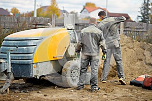 Filling the floor with concrete, screed and leveling the floor by construction workers. Smooth floors made of a mixture of cement