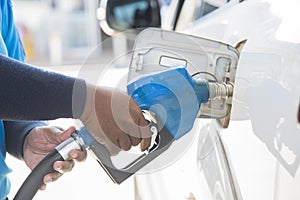 Filling gas at the station. Refill oil, gasoline, diesel vehicle.Hand refilling the car with fuel