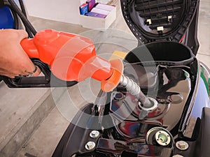 Filling gasoline into the motorcycle`s fuel tank