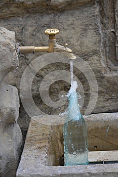 Filling a glass bottle at the fountain