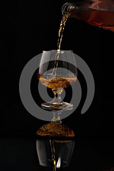 Filling a glass of brandy