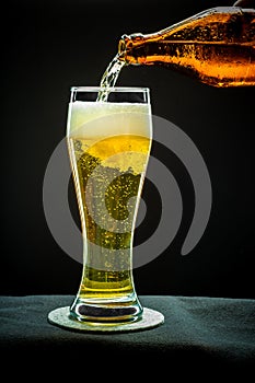 Filling glass glass with golden beer