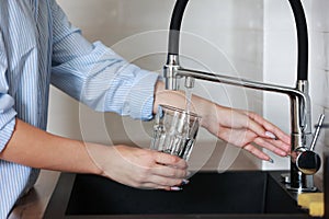 Filling glass of mains water, drinking water close-up. concept of pure drinking water. Water quality check concept. The