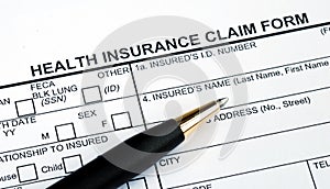 Filling the health insurance claim form photo