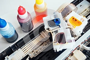 Filling inkjet printer with colored ink. Service for repair and maintenance of office equipment and equipment