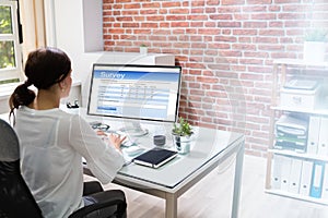Filling Online Survey Form On Computer At Desk