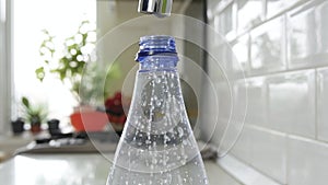 Filling a Plastic Bottle Drop by Drop with Water. Making Water Reserve in a Recipient. Water Economy Concept. Dripping water.