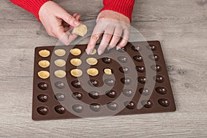 Filling raw shortcrust biscuit dough into silicone baking mold on wood background