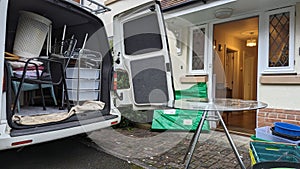 Filling a removals van with furniture from a house clearance