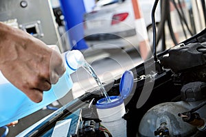 Filling the tank of windshield washer fluid