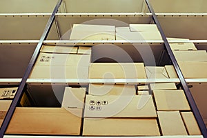 Filling the warehouse with boxes with goods. Loading racks with cardboard boxes