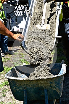 Filling a wheelbarrow full of wet concrete