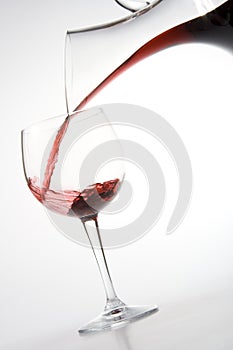 Filling wineglass from decanter photo