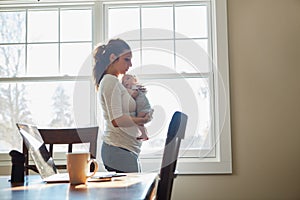 He fills her life with joy. a mother holding her newborn baby.