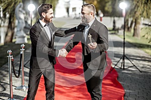 Film actors on the red carpet outdoors