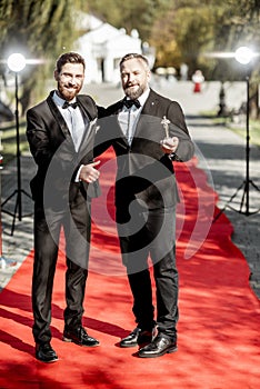 Film actors on the red carpet outdoors