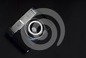 Film camera on black background