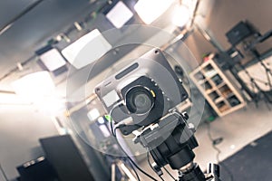 Film camera in broadcasting studio, spotlights and other equipment