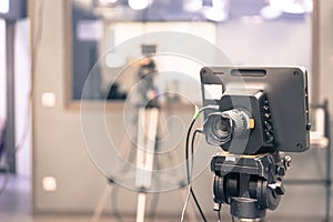 Film camera in broadcasting studio, spotlights and other equipment