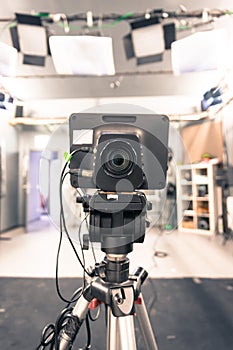 Film camera in broadcasting studio, spotlights and other equipment