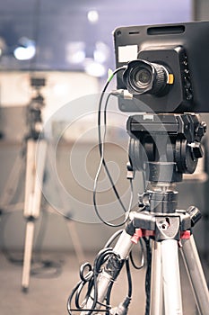 Film camera in broadcasting studio, spotlights and other equipment