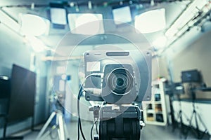 Film camera in broadcasting studio, spotlights and other equipment