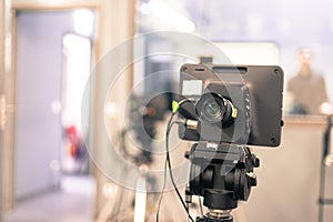 Film camera in broadcasting studio, spotlights and other equipment