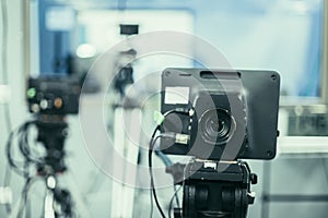 Film camera in broadcasting studio, spotlights and other equipment