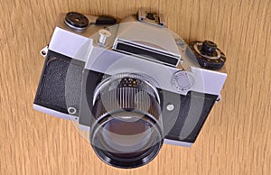 Film camera at wooden surface