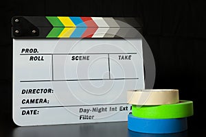 Film clapper board with colored marking tapes in internet content producer dark background studio