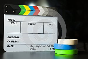 Film clapper board with colored marking tapes in internet content producer dark background studio