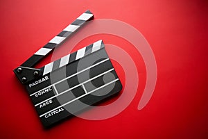 Clapper board on red background photo