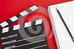 Film clapper on red background