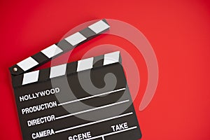 Film clapper on red background