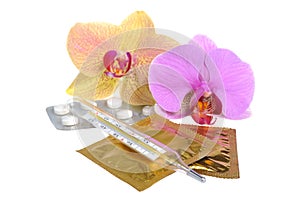 Film-coated tablets, condoms, thermometer with two orchid flowers