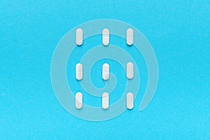 Film coated white oval tablets flat lay top view