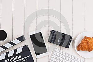 Film director desk with movie clapper board. Top view