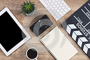 Film director`s desk on wood background. top view shot