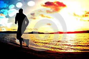 Film grain. Silhouette of sport active man running and exercising on the beach at sunset.