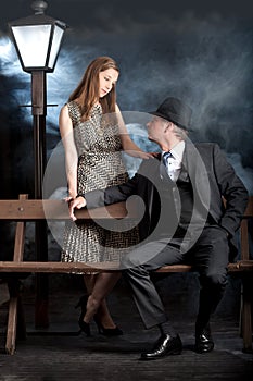 Film noir couple street lantern bench fog mist