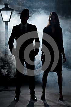 Film noir gangster couple street light mist