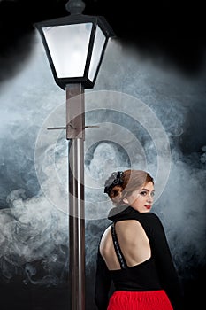 Film noir girl street lamppost fog back