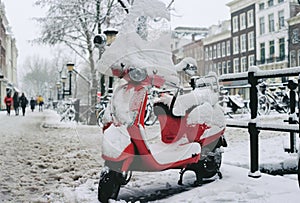 Film photo of red scooter with a loveheart covered in snow in the Netherlands photo