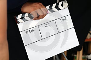 film production crew holding Film Slate on set