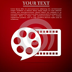 Film reel and play video movie film icon isolated on red background