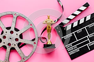 Film reel video tape with golden statue and movie clapper board