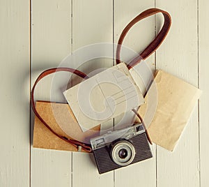 Film retro camera and several blank backgrounds on rough wooden table