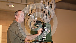 Film Technician Projecting 16mm Film