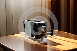 Film-viewing device slide projector lay on the table