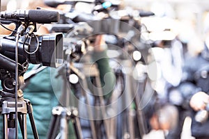 Filming media event or news conference with a television camera